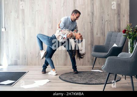 Smiling business couple dancing in office Stock Photo