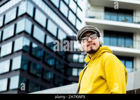 Smiling student talking on mobile phone at campus Stock Photo