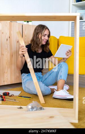 Young woman using digital tablet at home Stock Photo