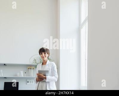 Smiling scientist with tablet PC at laboratory Stock Photo