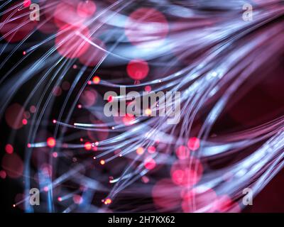 Illuminated red fiber optics carrying data Stock Photo