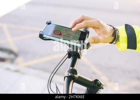 Delivery man with backpack using mobile phone by plants Stock Photo