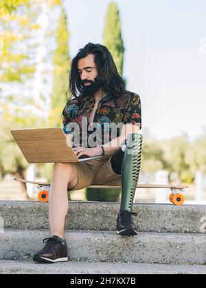 Happy bearded man taking selfie through smart phone in park Stock Photo