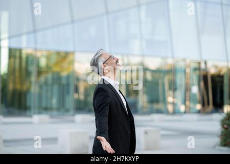 Businessman sitting cross-legged relaxing on seat Stock Photo