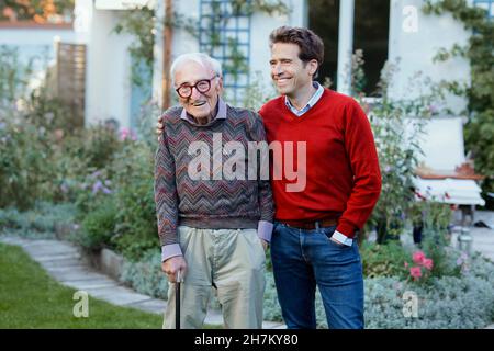 Happy man with father in backyard Stock Photo