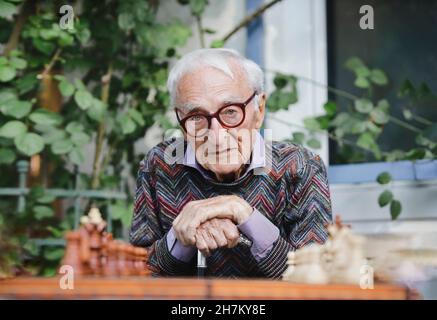 Sad senior man in front of chess board Stock Photo