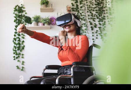 Smiling young woman with disability talking on smart phone Stock Photo