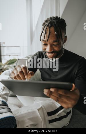 Young man using tablet PC at home Stock Photo