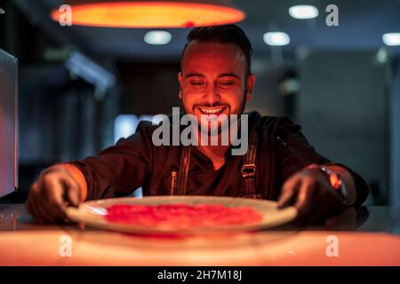 Smiling chef working in restaurant kitchen Stock Photo