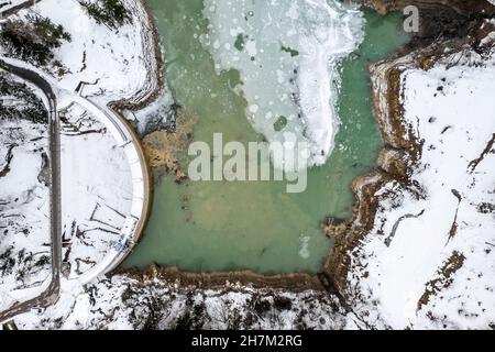 Reservoir amidst snow covered land at Carinthia, Austria Stock Photo