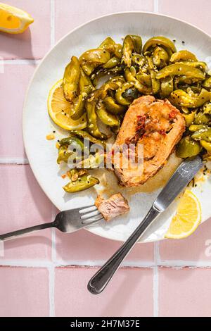 Stuffed fresh pork loin with lemon zucchini salad on table Stock Photo