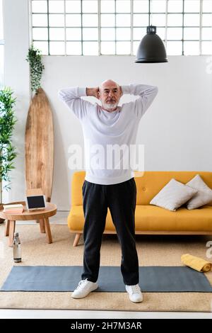 Active man doing push-ups on exercise at home Stock Photo