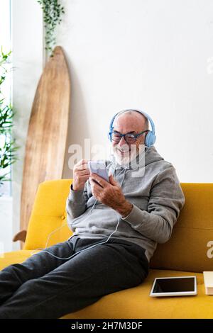 Senior Man Waving at Smartphone during Video Call on Christmas Stock ...