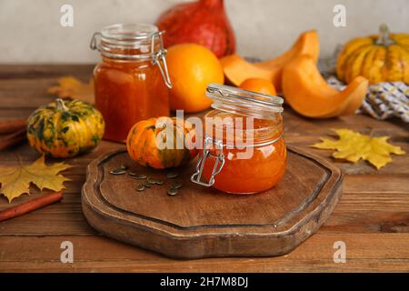 Jars of sweet pumpkin jam on table Stock Photo