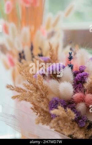 Weeding flowers background in hands. Bride holding her weeding bouquet of dry flowers. Handmade bouquet. Weeding decorations Stock Photo