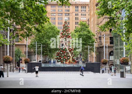 Large decorated Christmas tree with people around at Martin Place in Sydney, Australia on 20 November 20021. Ornaments can be seen on the tree. Stock Photo