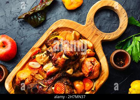 Pork knuckle or shank grilled with apples on cutting board Stock Photo