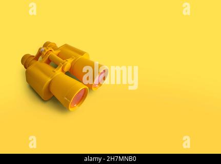 Yellow binoculars isolated on yellow background with copy space Stock Photo
