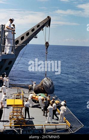 (29 Aug. 1965) --- The Gemini-5 spacecraft is brought aboard the recovery ship, USS Lake Champlain after a successful landing at the end of its mission Stock Photo
