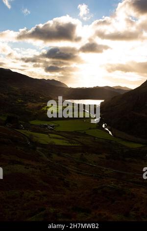 Nant Gwynant, Gwynant vally, with Llyn Gwynant in the background with hazy late evening sunlight. Part of Snowdonia National Park Stock Photo