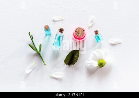 samples of natural cosmetics and flowers on a white background Stock Photo
