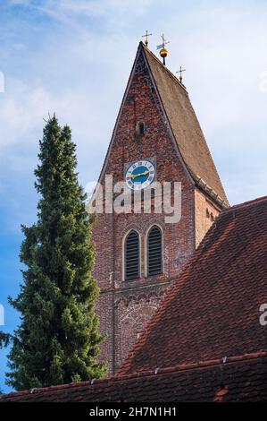 Brick church tower with clock, Catholic town parish church of St. Justina in Bad Woerishofen, Swabia, Allgaeu, Bavaria, Germany Stock Photo
