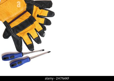 Yellow gloves worker, builder and screwdriver on white background Stock Photo