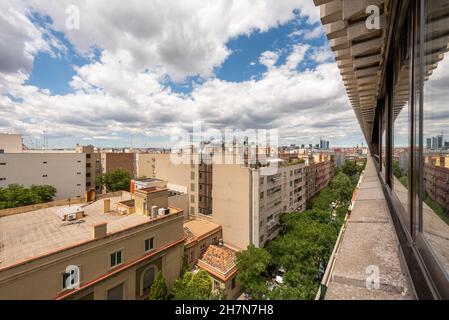 Views of the Madrid skyline from a penthouse apartment dedicated to vacation rental a day with summer clouds Stock Photo