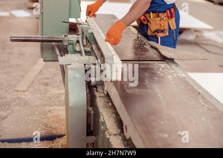 Male worker hands using woodworking machine in workshop Stock Photo