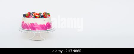 Delicate cake decorated with fresh berries strawberries blueberries white plain background. Festive dessert with berries Stock Photo