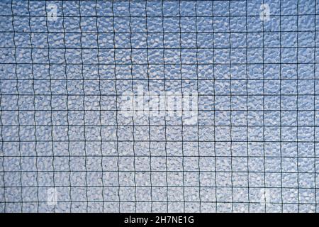Close up of frosted safety glass against a blue sky Stock Photo