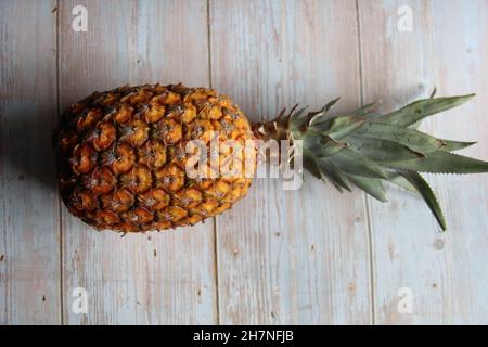 Hawaiian pineapple, isolated, on an old wooden table, Top view. Stock Photo