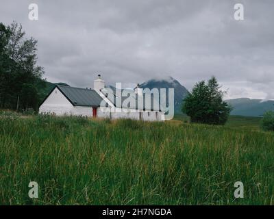 A lone typical white croft in the remote Highland summer landscape of Glencoe west Highlands Scotland UK - Scotland croft architecture landscape Stock Photo