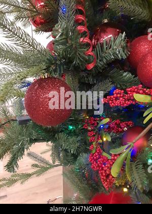 Christmas tree decorated with red baubles. Stock Photo
