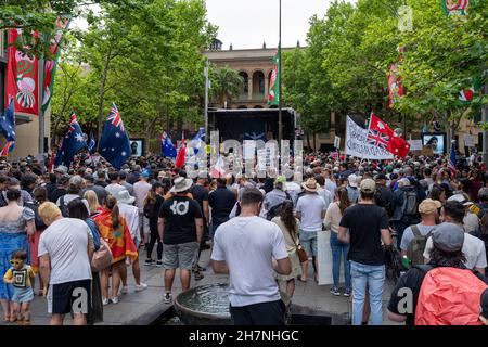 Men, women, children protest holding banners, flags against vaccine mandates, lockdown, restrictions in Martin Place, Sydney, Australia 20 Nov 2021 Stock Photo