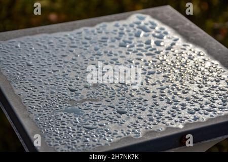 Drops of Rain or Water Drop on the metallic post, shiny and scattered. Stock Photo