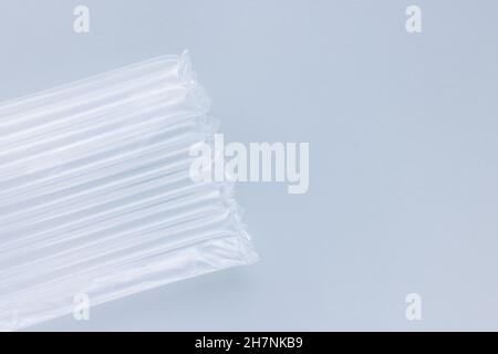 Air column cushioning sleeve wrap for bottles on blue background. Bubble foil for wrapping. Close up, pollution concept Stock Photo