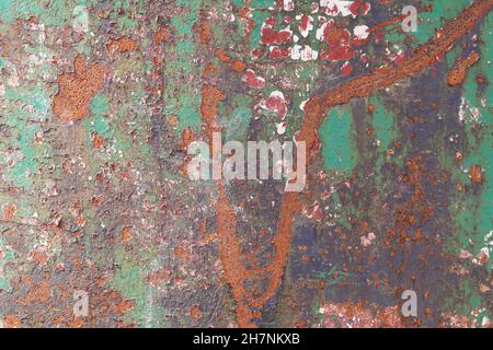 Rusted metal wall with layers of peeling paint. Backgrounds and textures. Stock Photo