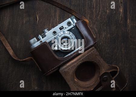 Retro photo camera with a leather case. Stock Photo