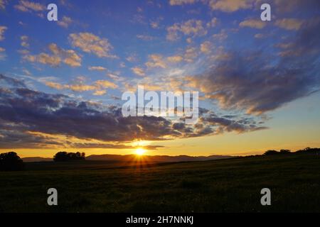 Sunset in the Sauerland. Landscape with setting sun in the evening. Stock Photo