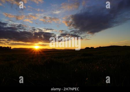 Sunset in the Sauerland. Landscape with setting sun in the evening. Stock Photo