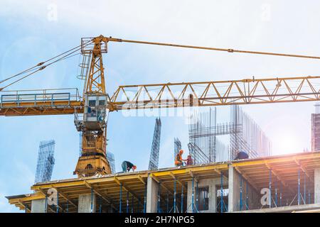 2021-05-21 Kyiv, Ukraine. Day at the construction site. Workers on the roof of the new multi appartment building. Development of the new city district Stock Photo