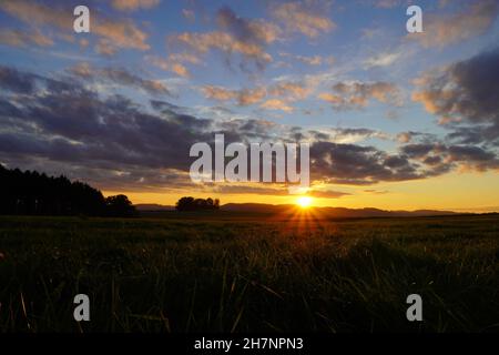 Sunset in the Sauerland. Landscape with setting sun in the evening. Stock Photo
