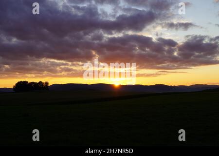 Sunset in the Sauerland. Landscape with setting sun in the evening. Stock Photo