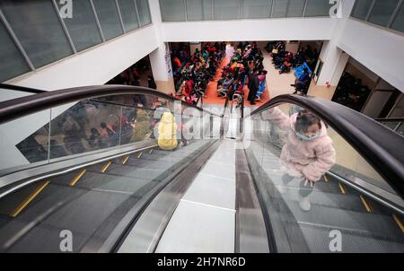 Kathmandu, Bagmati, Nepal. 24th Nov, 2021. A small girl plays at an escalator while crowd of people wait for their turn for health check-up at a hospital in Kathmandu, Nepal on November 24, 2021. (Credit Image: © Sunil Sharma/ZUMA Press Wire) Stock Photo