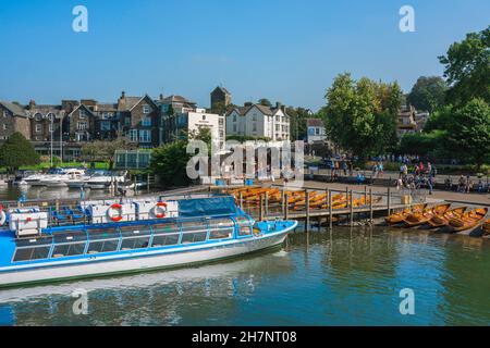 Bowness, view in summer of a tour boat moored at a jetty beside the Promenade in Bowness-on-Windermere, a scenic village on Lake Windermere, England Stock Photo