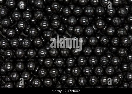 Black bead background with white highlights. Shiny abstract close up Stock Photo