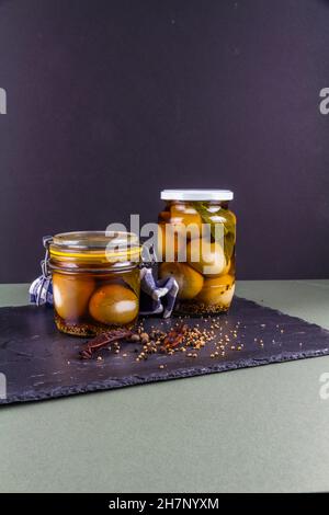 Two jars of eggs pickled in  dark malt vinegar, portrait with copyspace top and bottom. Stock Photo