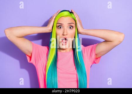 Photo of astonished lady scare horror movie touch hand different color hairdo isolated over purple background Stock Photo