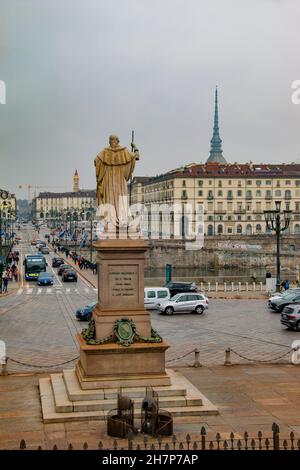 Statue of a King Vittorio Emanuele I, walking forward, holding a staff in his right arm, facing the Ponte Vittorio Emanuele I over the River Po, Turin Stock Photo